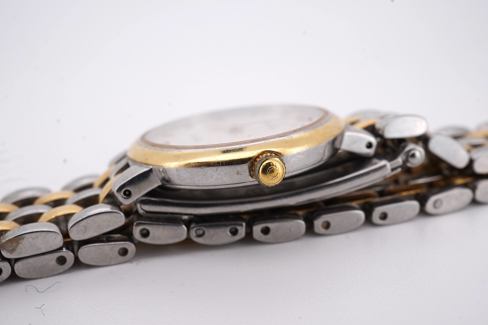 A lady's steel and gold plated Omega de Ville quartz wrist watch, with baton and quarterly Roman numerals, on a stainless steel and gold plated bracelet, case diameter 24mm, no box or papers. Condition - poor to fair